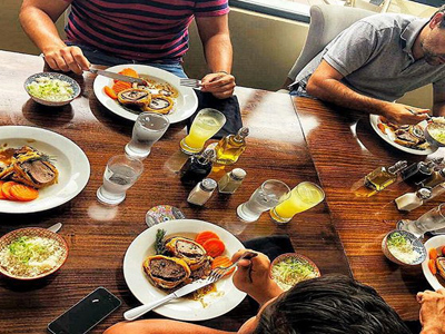 6-	Picture of guests eating dinner at the Costa Rica Medical Center Inn, San Jose, Costa Rica.  The picture shows lavish food spread across a large table.