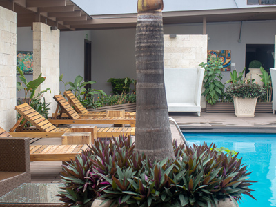 Picture of the pool at the Costa Rica Medical Center Inn, San Jose, Costa Rica.  The picture shows lounge chairs adjacent to the pool